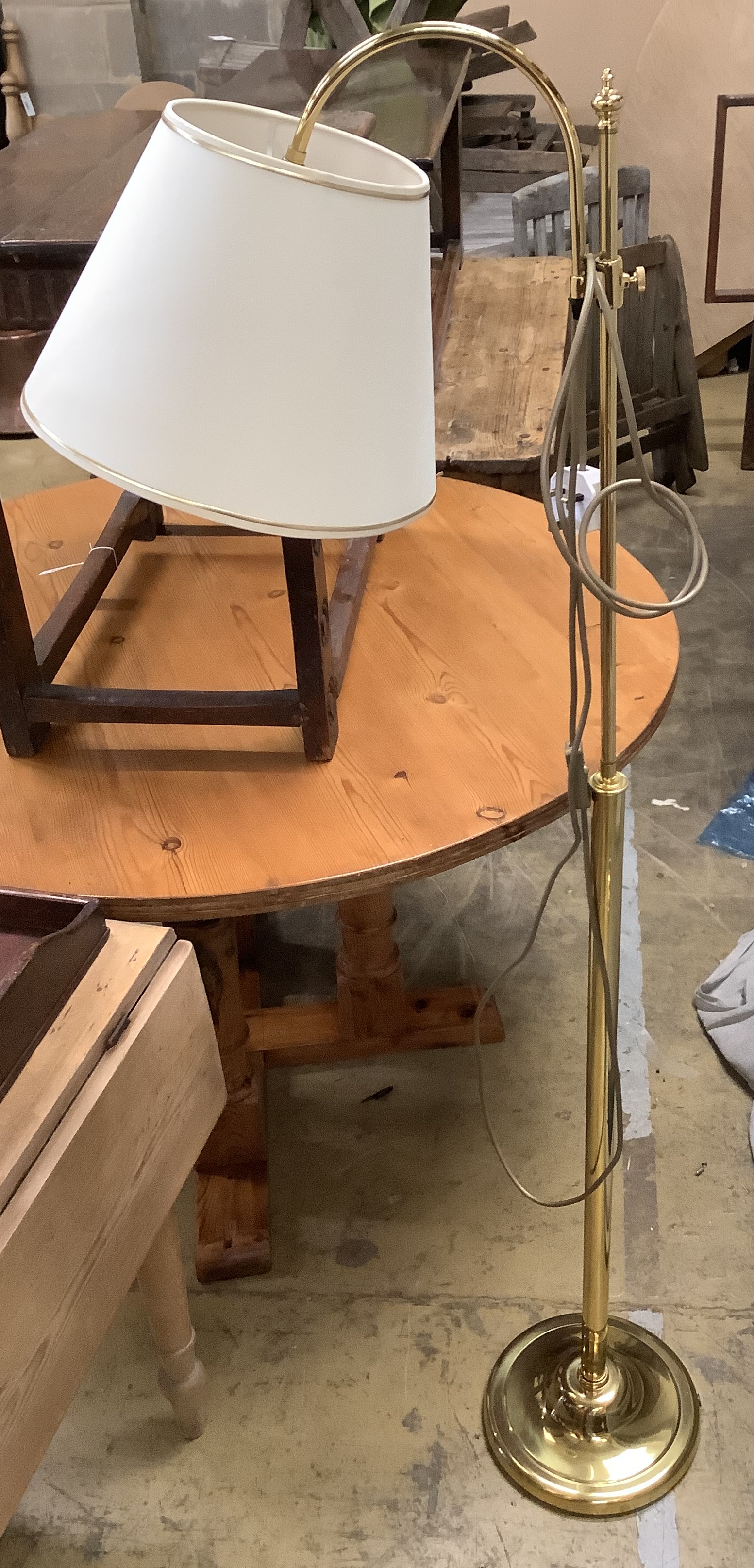 A pair of gold-coloured metal adjustable floor lamps